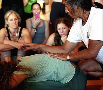 Rodney Yee demonstrating Yoga technique on student