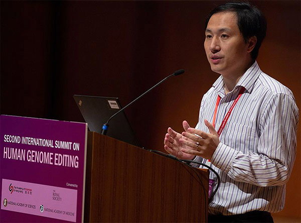 Geneticist He Jiankui at a podium labelled Second International Summit on Human Genome Editing.