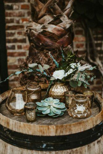 sage green wedding recetion decorations details with white fresh flowers and greenery on wine barrel vicky baumann