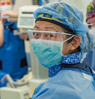 Healthcare worker in scrubs and mask