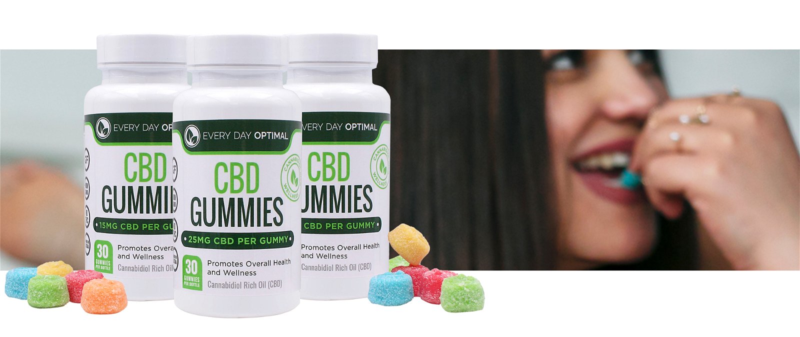 3 different potencies of CBD gummies sit side by side in front of a photo of a young woman eating a blue CBD gummy