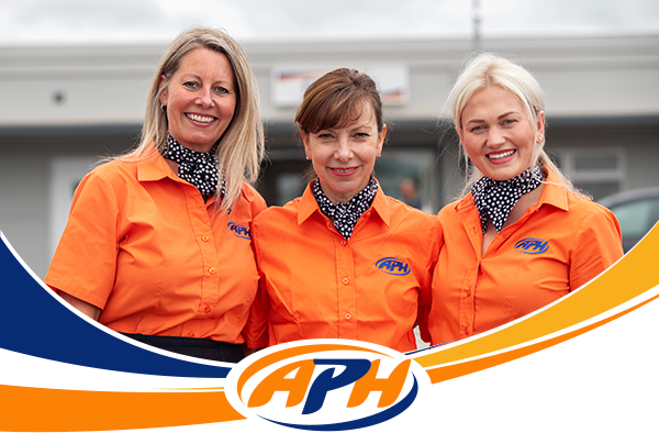 6 APH team members smiling wearing hi viz jackets, underlined by the APH logo