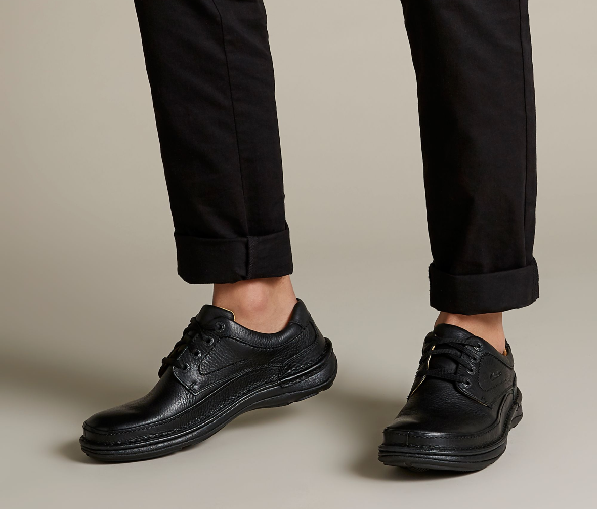 shoes on feet image of Nature Three in black leathe rlinks to product page