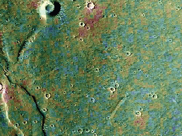 A vivid multihued image shows craters, peaks and other geological formations on Mars.