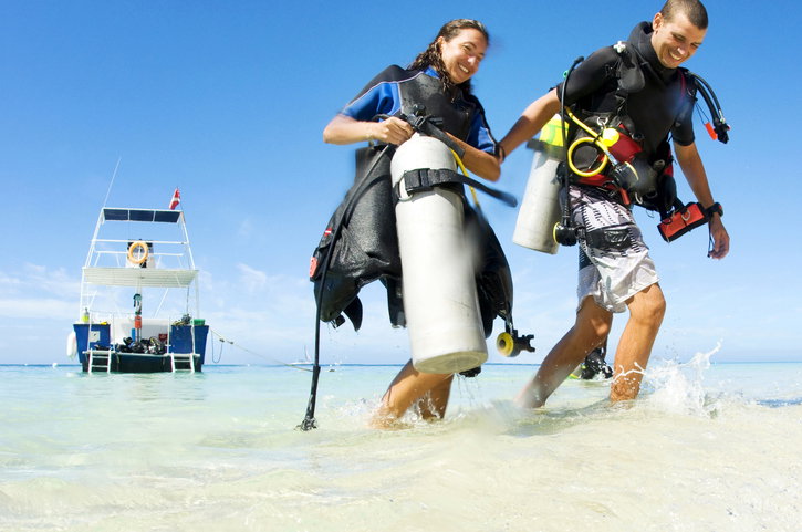 Couple on beach with scuba gear Couple on beach with scuba gear