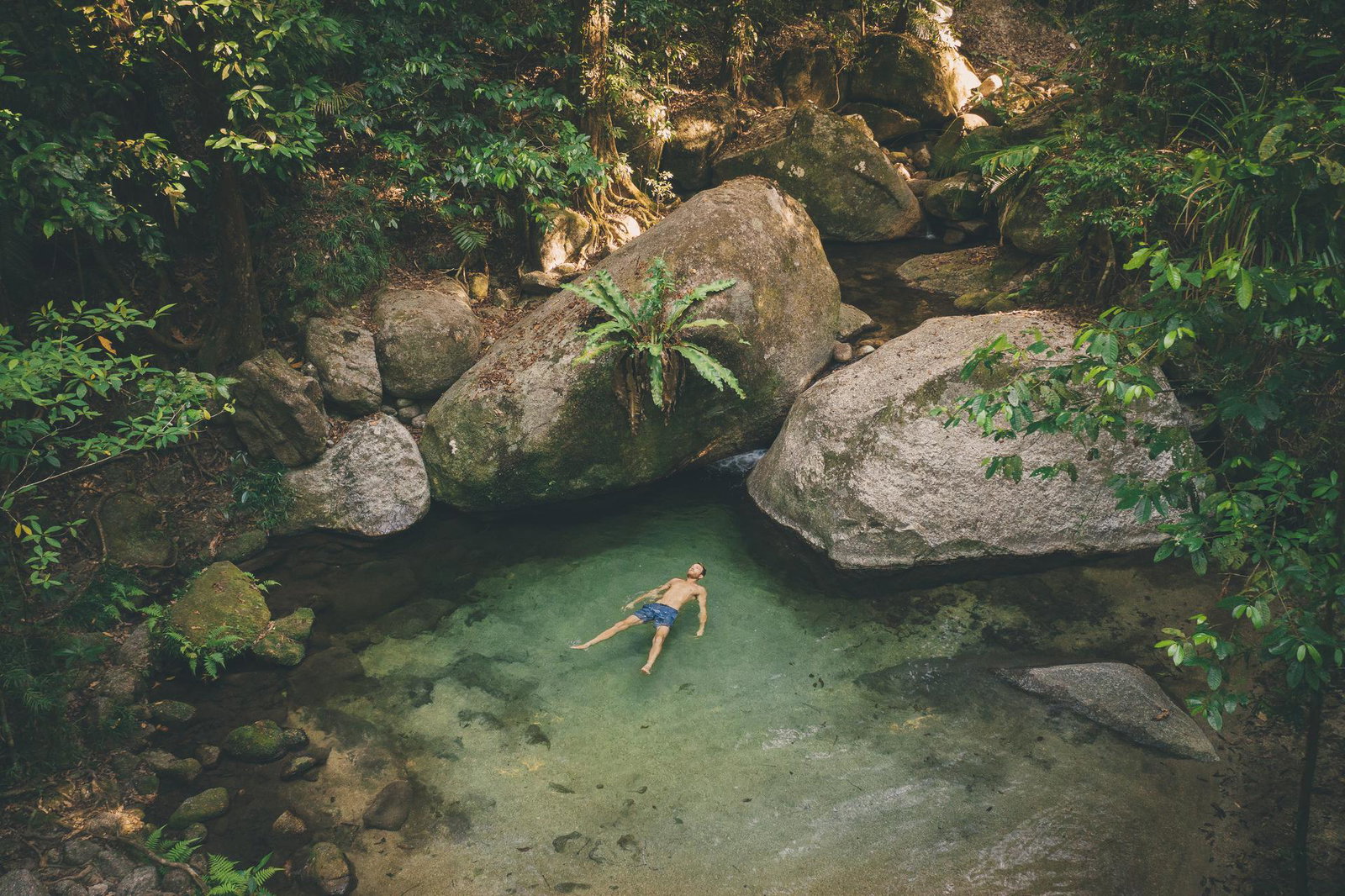 man relaxing in rockpool man relaxing in rockpool