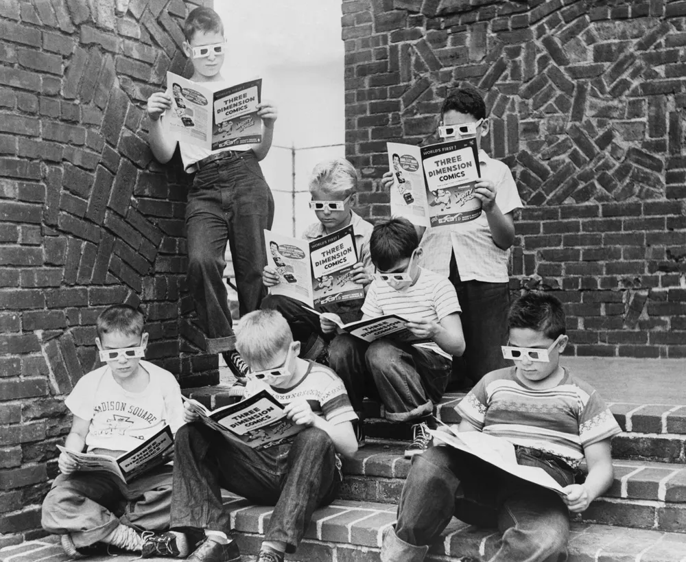 A group of boys read 3-D comic books at the Madison Square Boys Club.