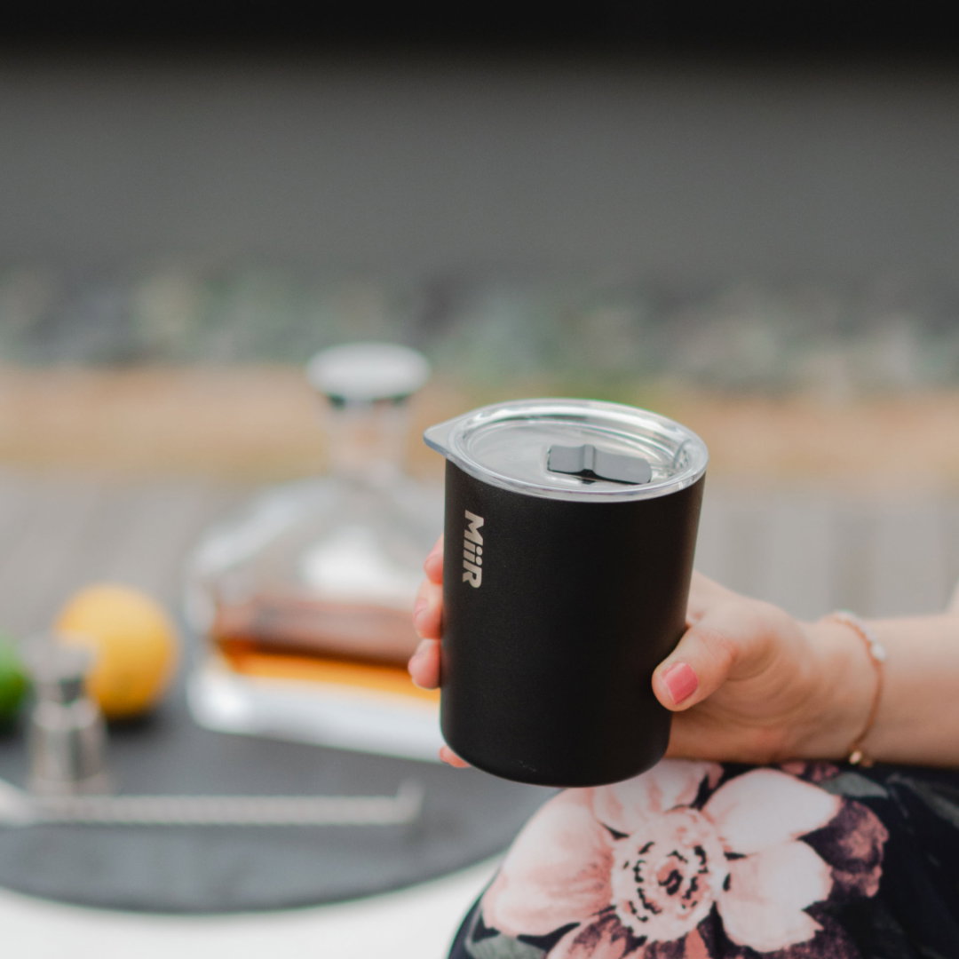 woman holding a MiiR glass