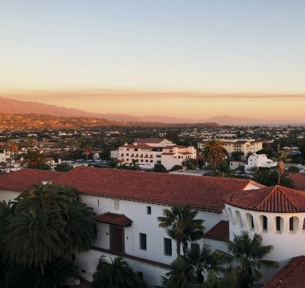 City skyline view of Santa Barbara at sunset, with golden mountains in the distance