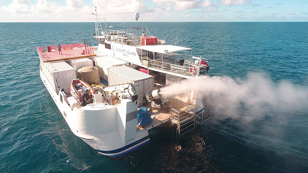 A boat using the sea-spraying cloud brightening system over the Great Barrier Reef in Australia during a 2021 trial.