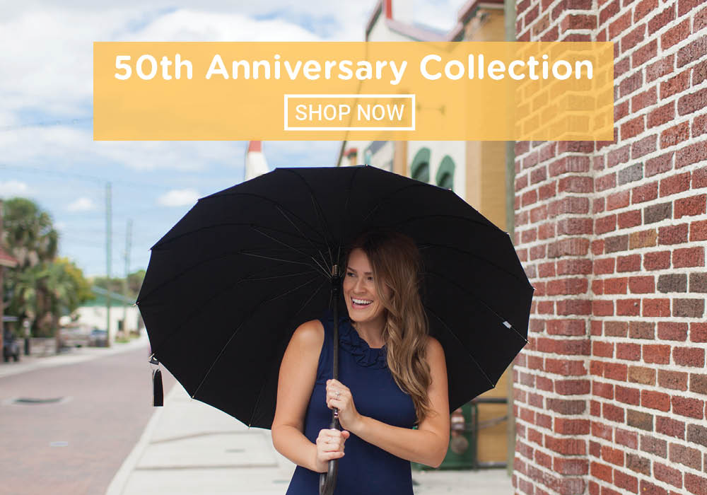 50th Anniversary Collection - a woman holding a 50th anniversary Totes umbrella