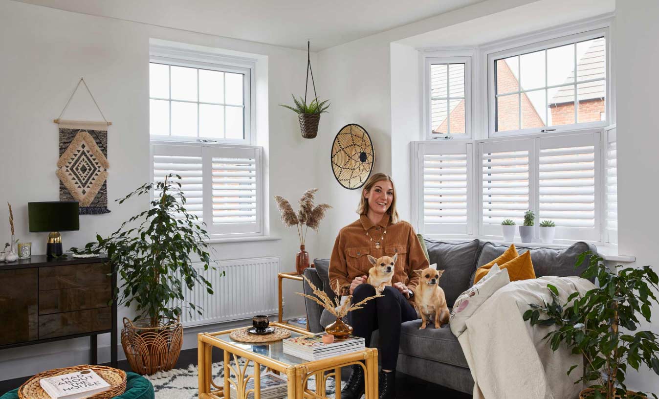 Hillarys customer Lara Hall in her living room with cafe style shutters