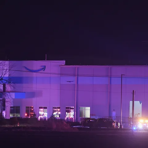 First responders surround a damaged Amazon Distrib
