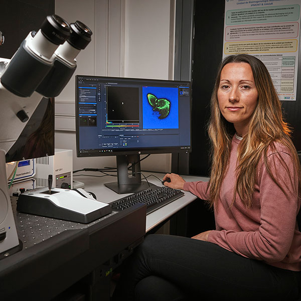 María E. Francia uses a computer that shows a magnified parasite on the screen.