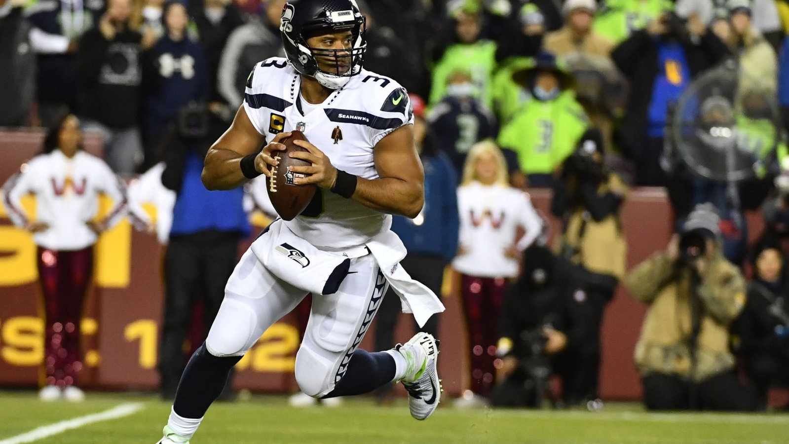 Seattle Seahawks quarterback Russell Wilson (3) rolls out against the Washington Football Team during the first half at FedExField.