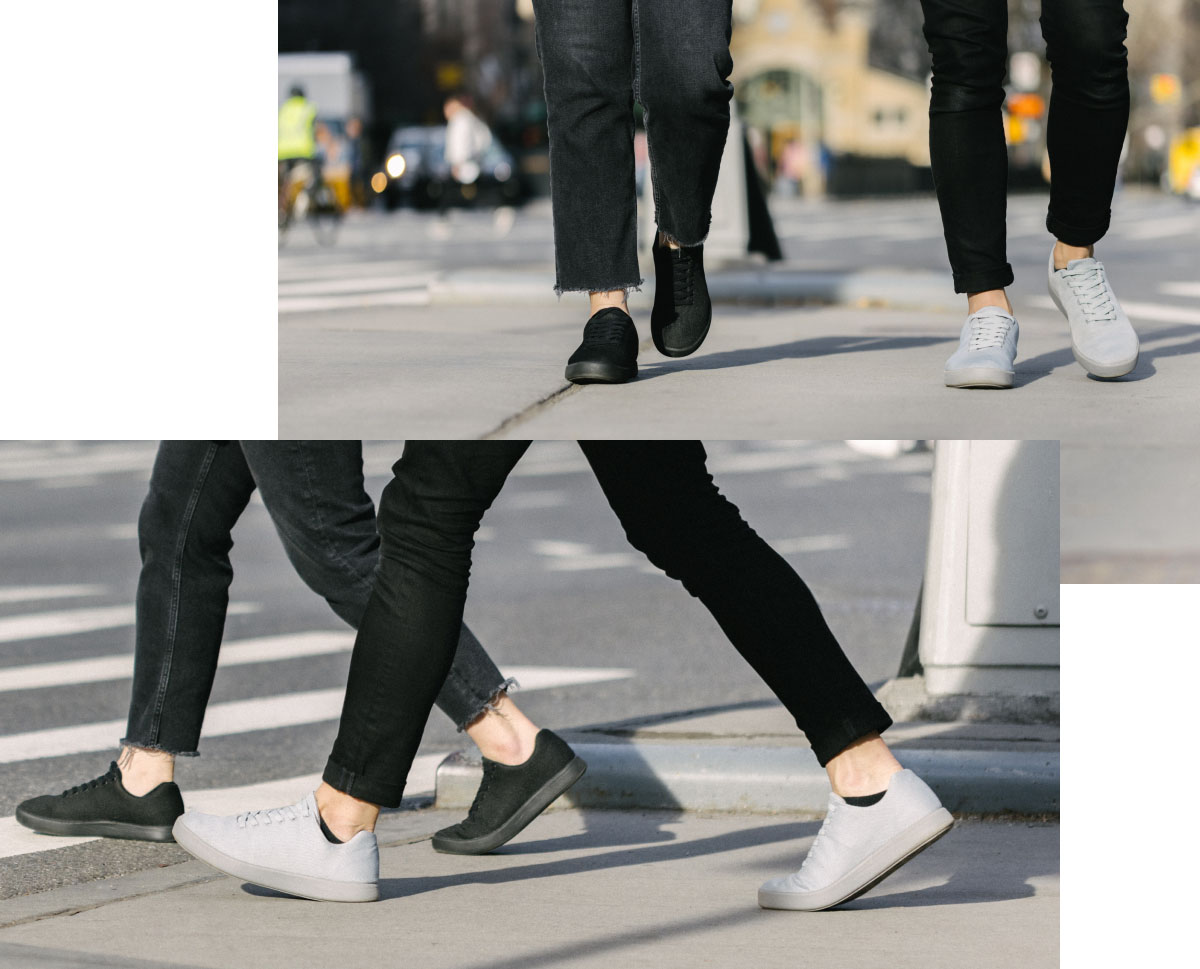 Friends walking together, both wearing pairs of Atoms Model 000 in black and gray.
