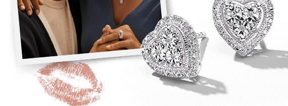 Photo of a happy couple - man whispering in woman's ear and diamond heart earrings