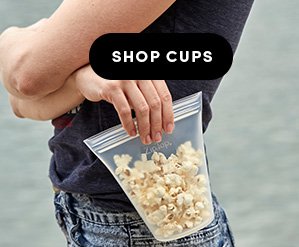 A woman holding a Frost Zip Top cup filled with popcorn. Shop Cups
