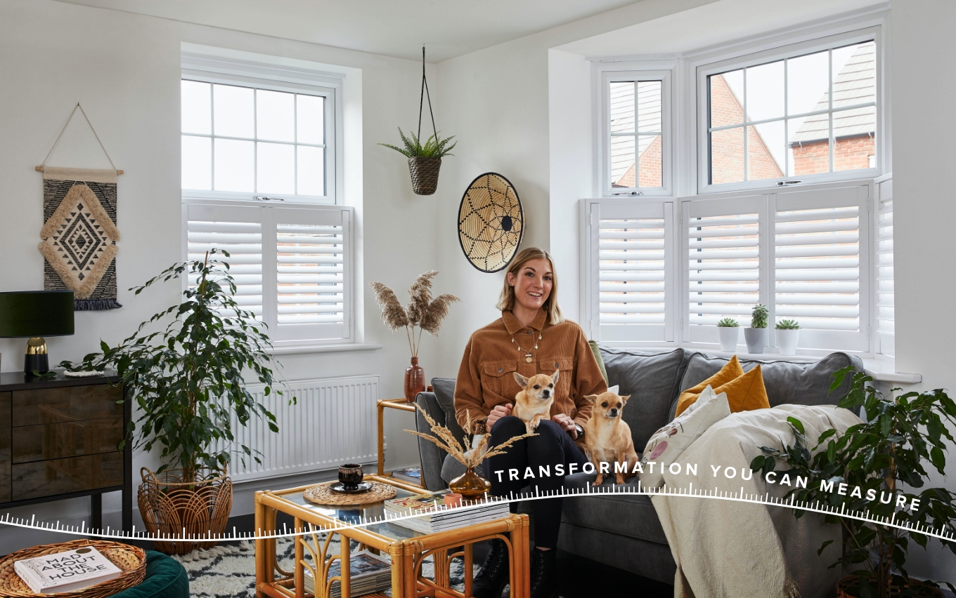 Lara Hall sat in her living room with two cafe-style shutters in the windows on either side of her