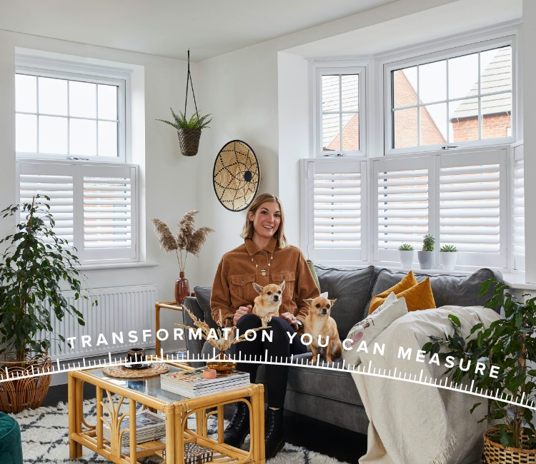 Lara Hall sat in her living room with two cafe-style shutters in the windows on either side of her