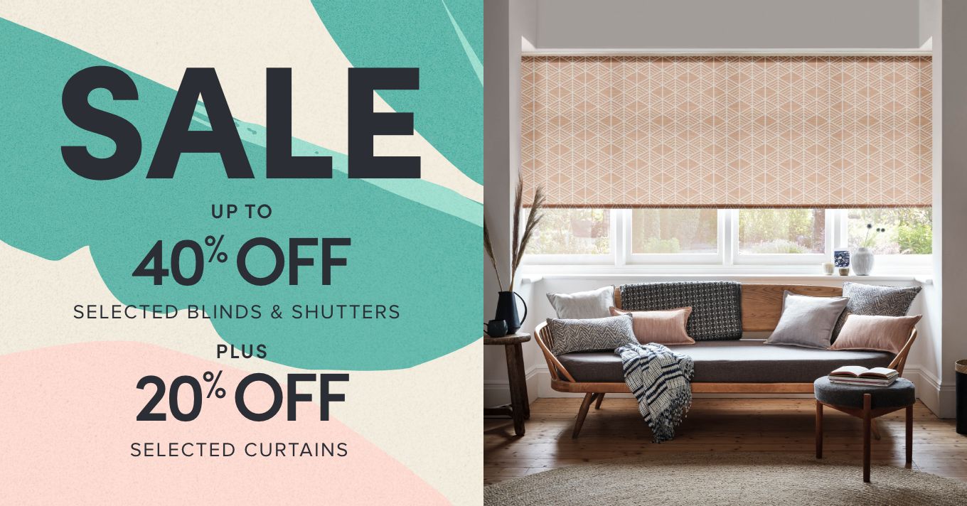 SPRING SALE, up to 40% off selected blinds and shutters. 20% off selected curtains. - Coral roller blinds with geometric pattern covering a lounge window