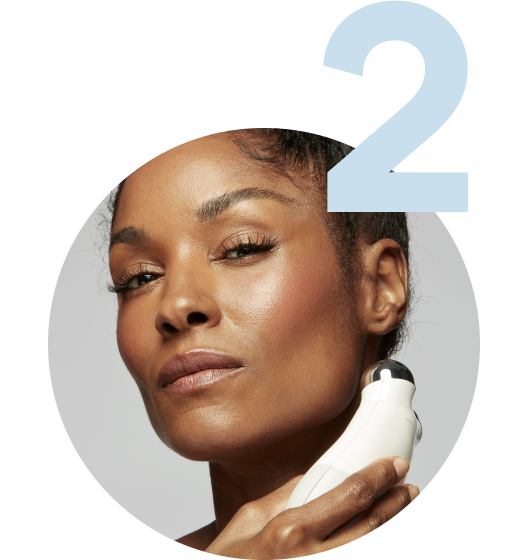 Model using the Trinity Device on her jawline