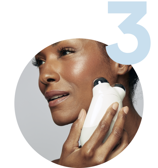 Model using the Trinity Device on her cheekbones to help improve facial contour & tone.