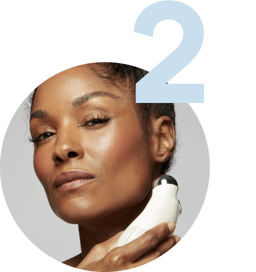 Model using the Trinity Device on her jawline