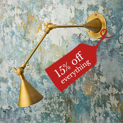 Egret wall light in antiqued brass and silver