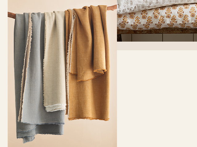 Image of rustic linen blankets and throws hanging from a branch