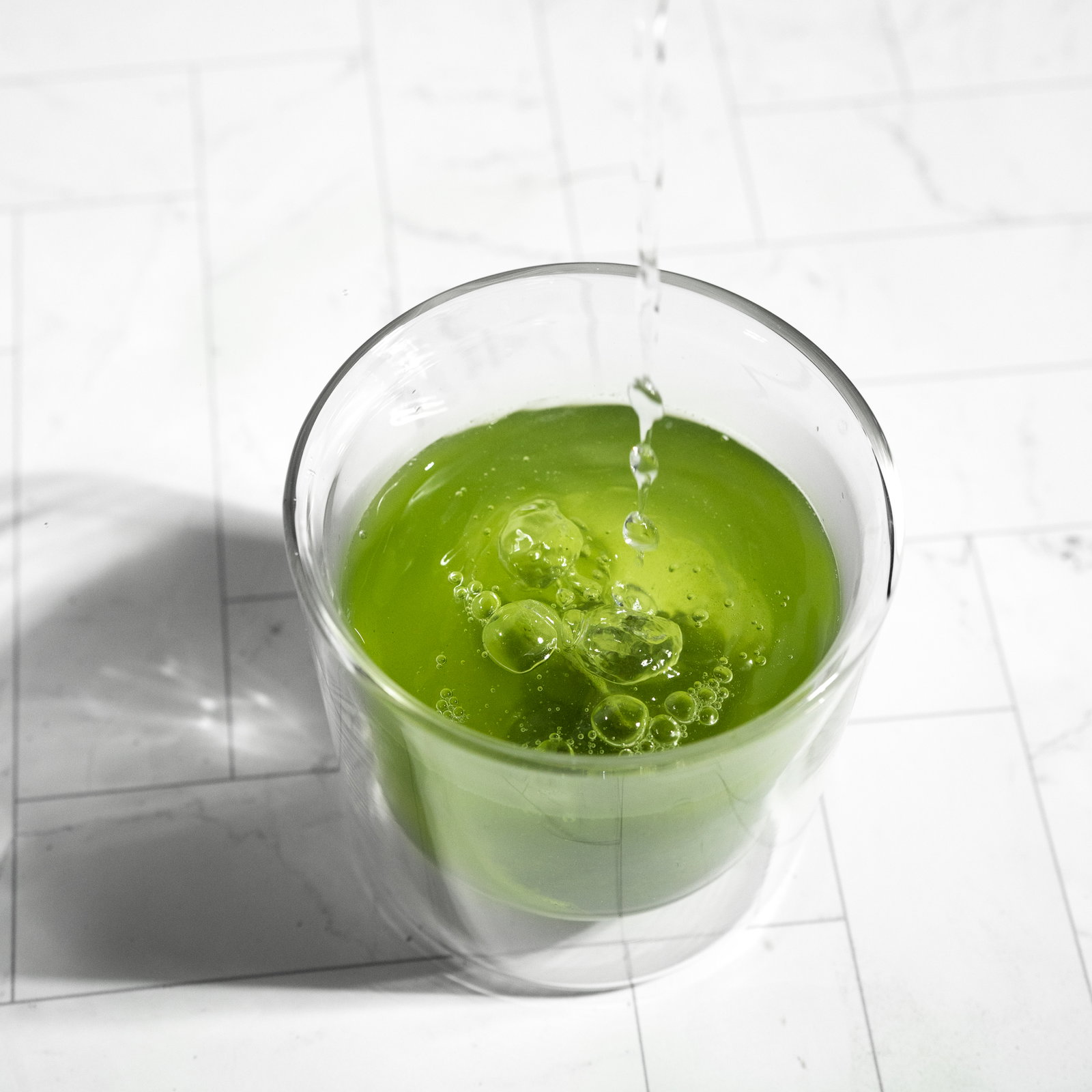 Vividly green cup of steeped matcha + green tea