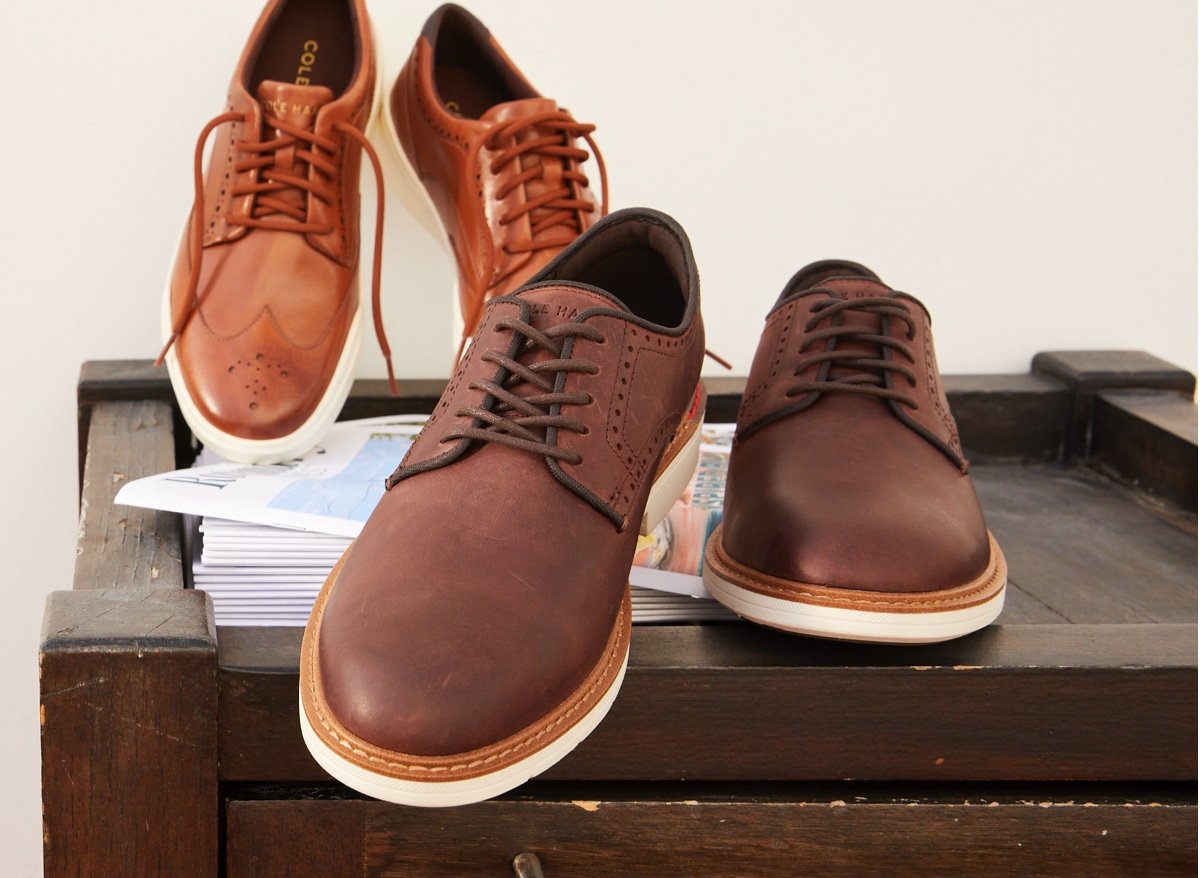Two pairs of brown leather shoes with white soles