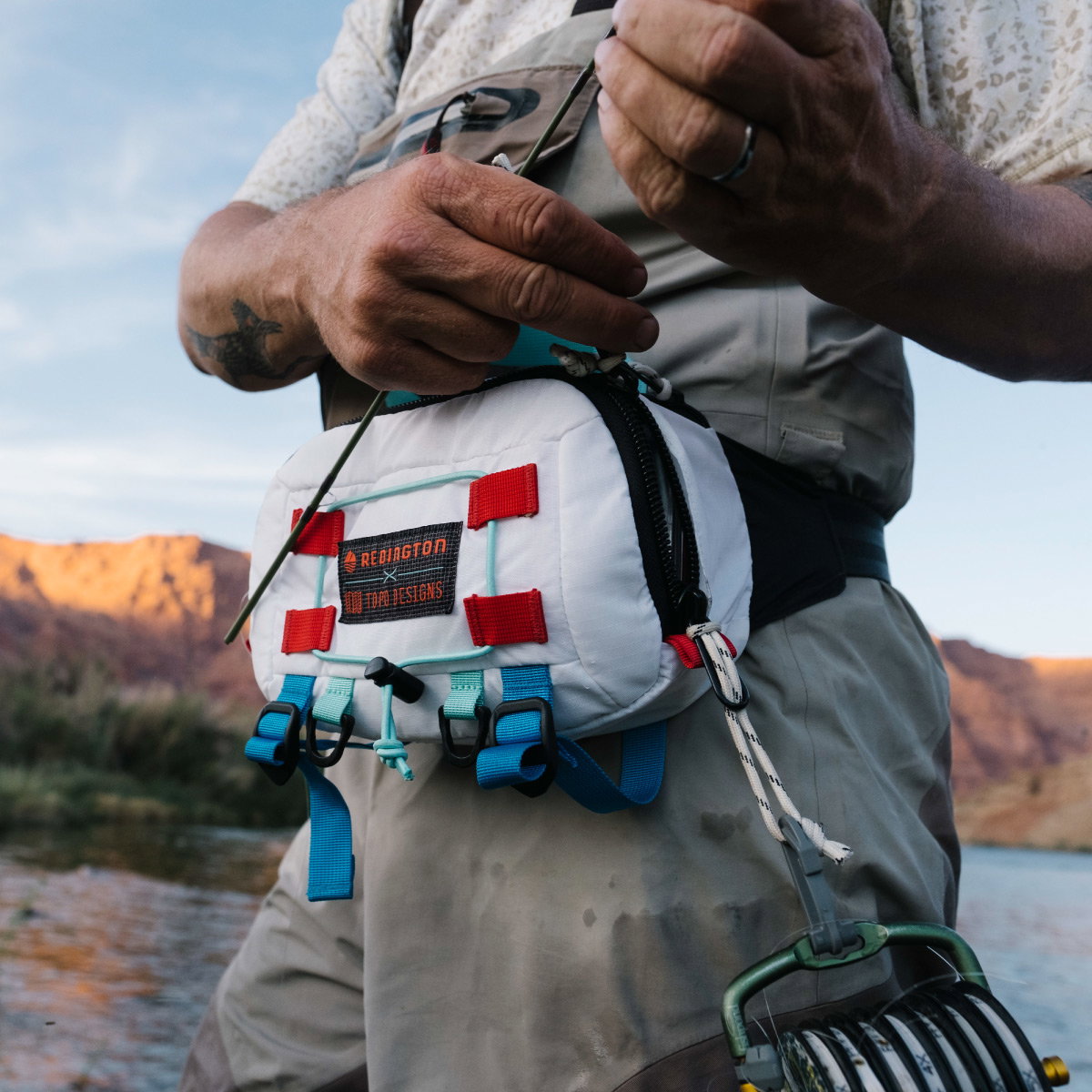 CLOSE UP OF THE COLLAB HIP PACK WORN AROUND THE WAIST WHILE WADING