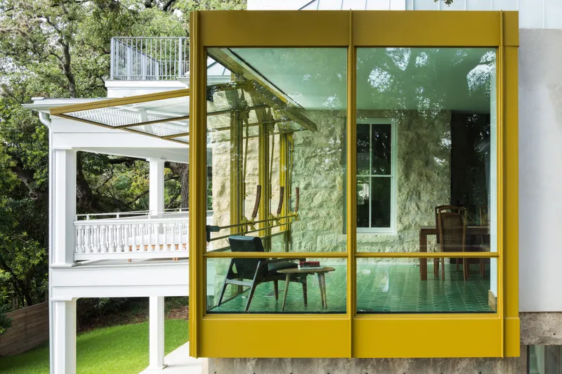 extension renovation with white porch and a yellow greenhouse-inspired room