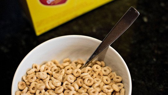 A bowl of Cheerios with a spoon