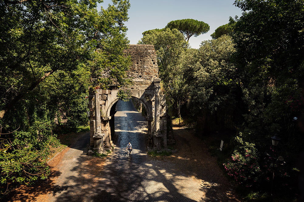 A picture of someone riding a bike along a stone path