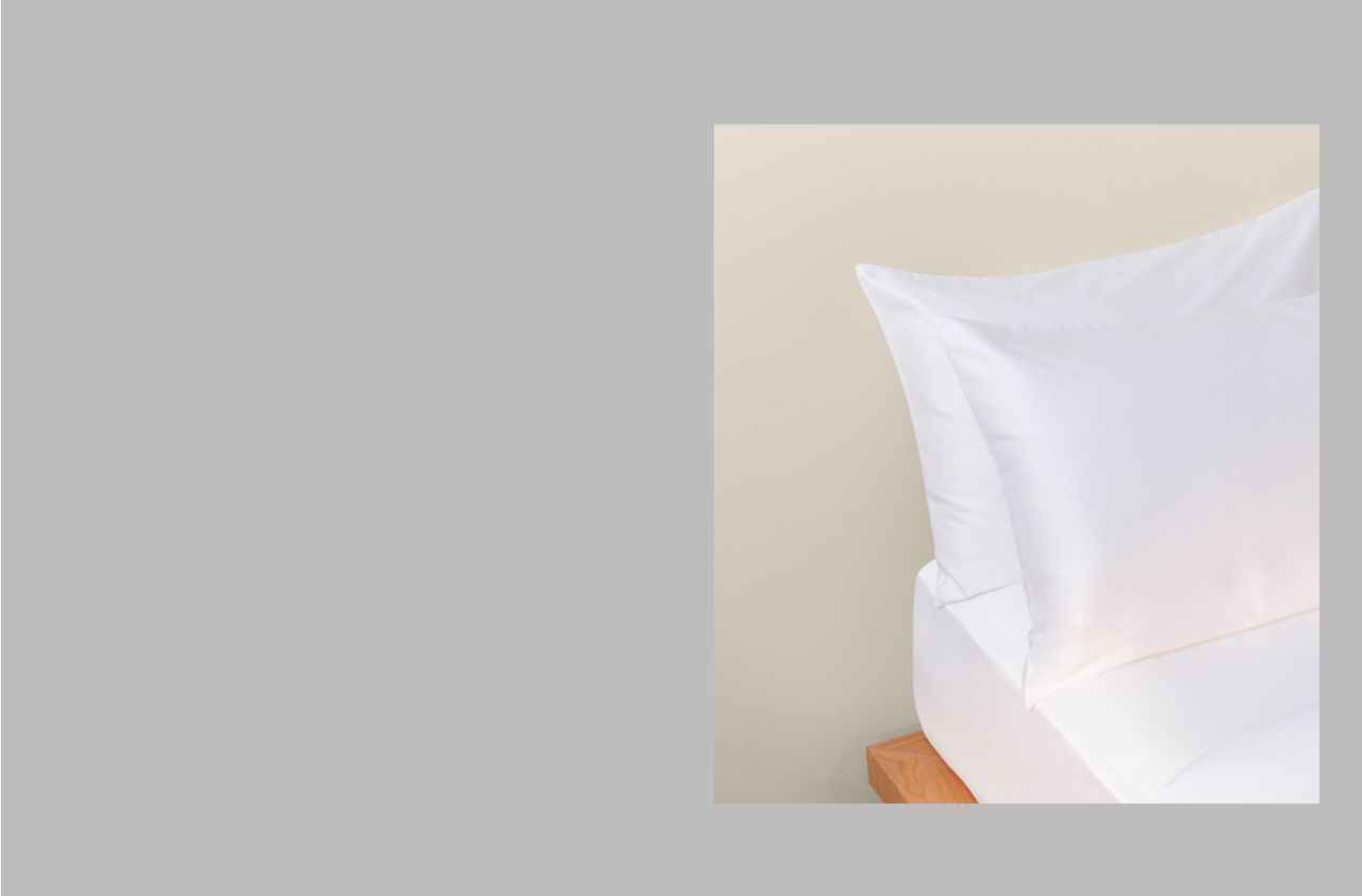 A close up image of two white pillowcases