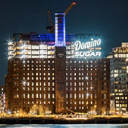 The Massive ‘Domino Sugar’ Sign Lights Up the Williamsburg Skyline Once Again, Marking Progress in the Landmark’s Transformation
