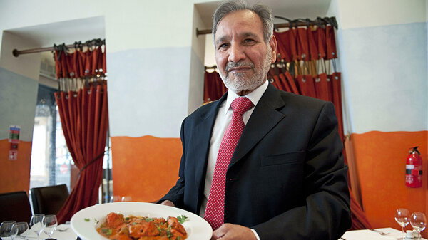 Ahmed Aslam Ali, the owner of the Shish Mahal restaurant in Glasgow, is pictured with a plate of Chicken Tikka Masala in his restaurant, on July 29, 2009.