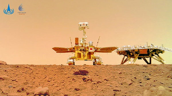 A selfie of China's first Mars rover Zhurong with the landing platform visible from the surface of Mars.
