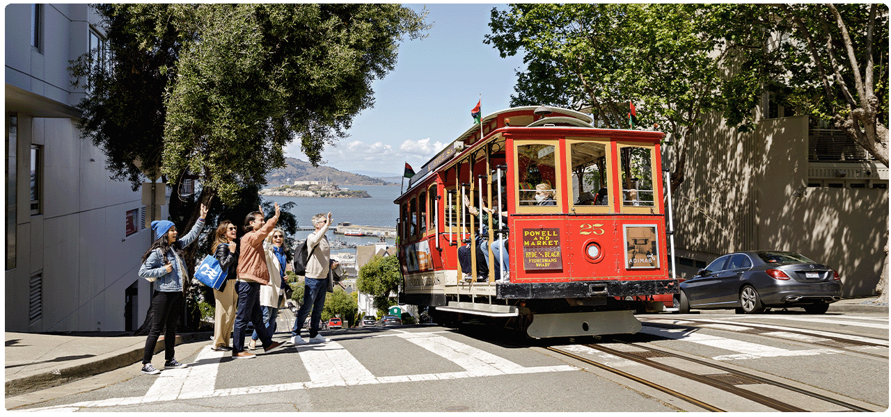 People waving to people on San Francisco trolley. View cruises to the California Coast.