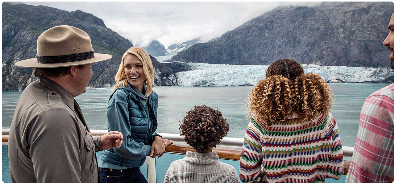 Park Ranger and family of four on deck learning about the glaciers in Alaska. View cruises to Alaska.