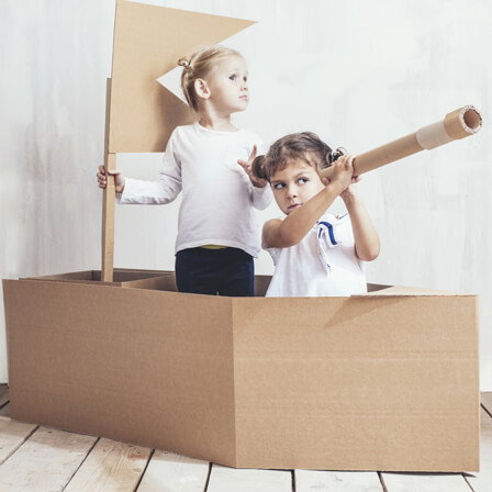 Photo of two children acting like they are sailing a ship