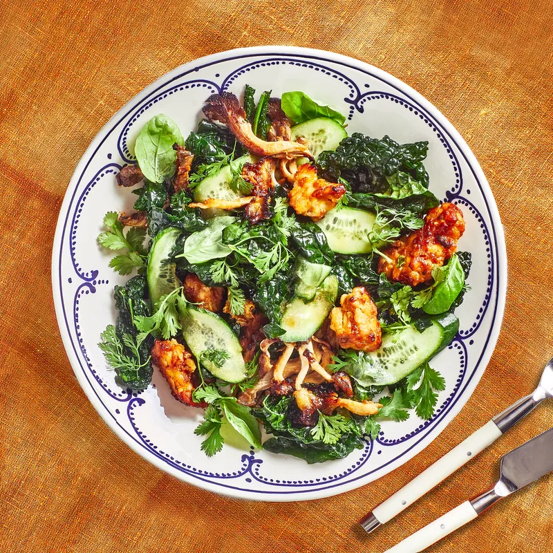 Plate of Kale Salad With Roasted Tempeh and Mushrooms