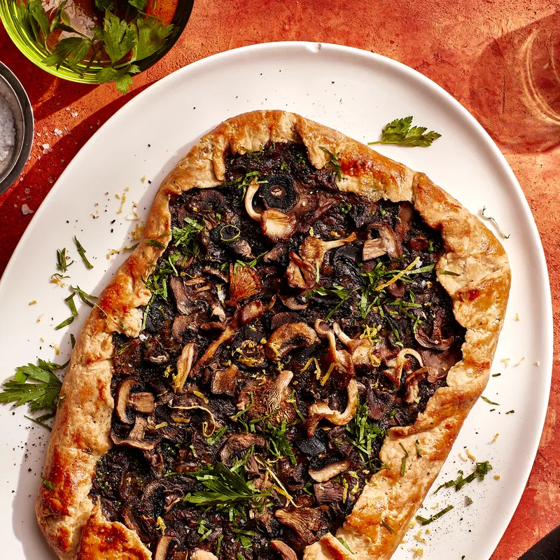 A rectangular Cheesy Mushroom Galette on a white serving platter