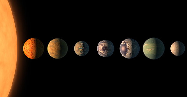 Seven planets of roughly equal size and in various shades of red, blue and green are lined up in a row. They are illuminated by a bright orange star many times their size that is partially visible on the left edge of the image.