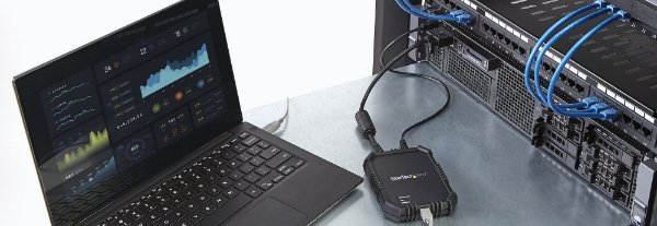 Desk with laptop connected to KVM adapter