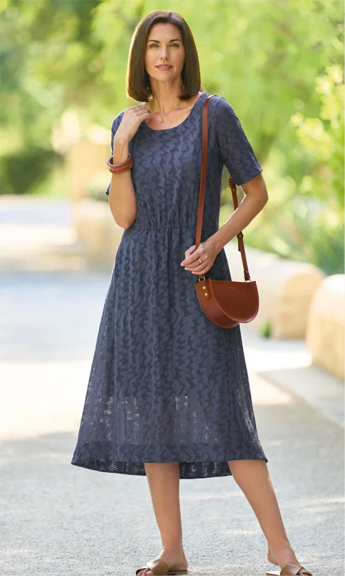 Modern, semi-sheer dipped hem dress