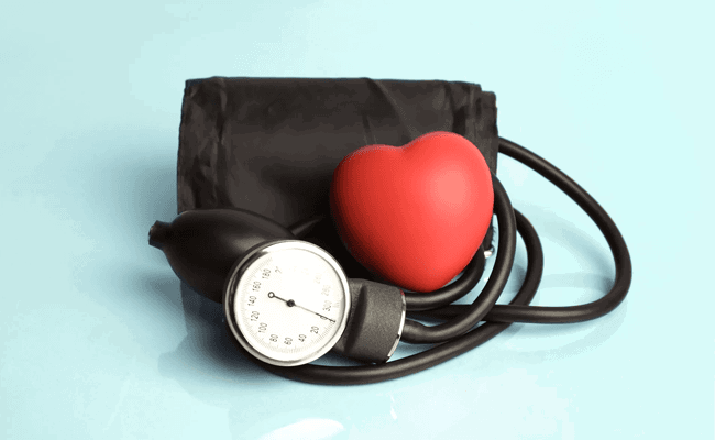 Blood pressure cuff with a red plastic heart on top