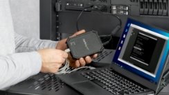 A close up of a KVM and a laptop